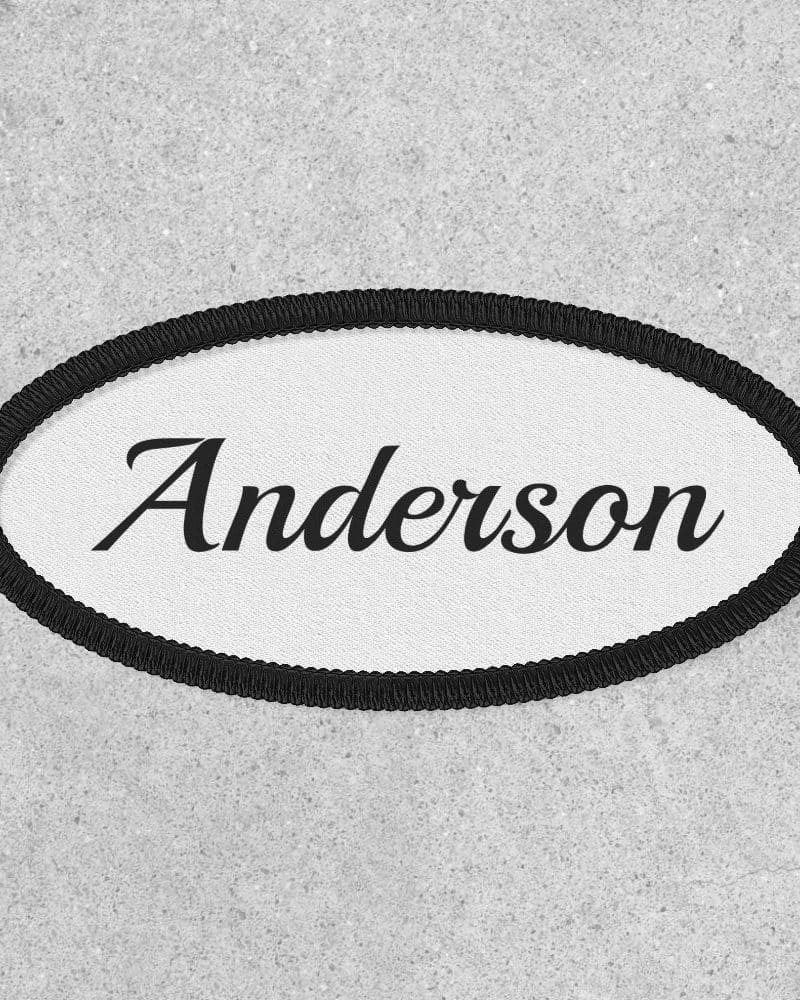 Oval white name tag with black border and the name Anderson in a cursive font.