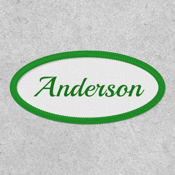 Oval Name Tag With Green Border, Displaying The Name Anderson In Green Cursive Lettering.