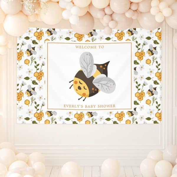 Baby Shower Banner Featuring A Large Cartoon Bee And Text That Reads Welcome To Everly'S Baby Shower. The Banner Has A Repeating Pattern Of Smaller Bees And Honeycombs.