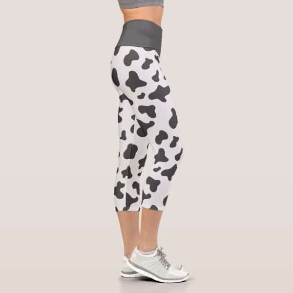Cow Print Cropped Leggings On A Woman'S Legs.