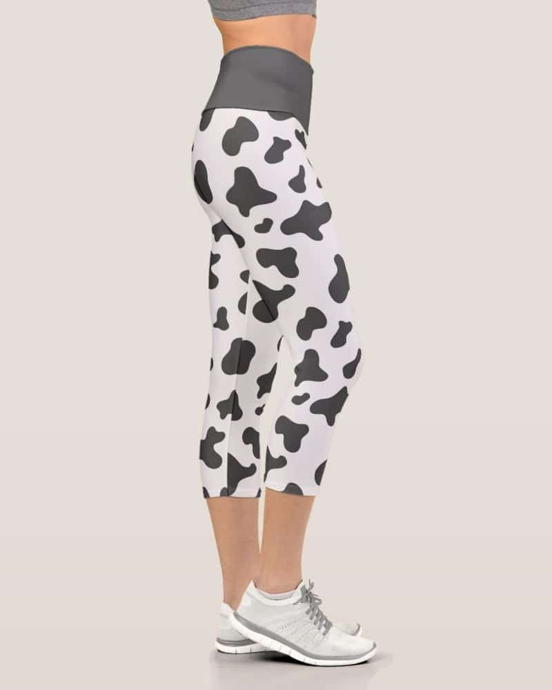 Cow print cropped leggings on a woman's legs.