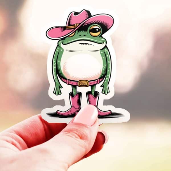 A Sticker Of A Frog Wearing A Pink Cowboy Hat And Pink Boots.