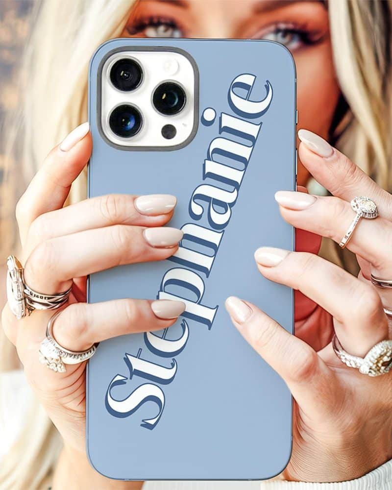 Woman's hands holding a light blue iPhone case with the name Stephanie printed on it.