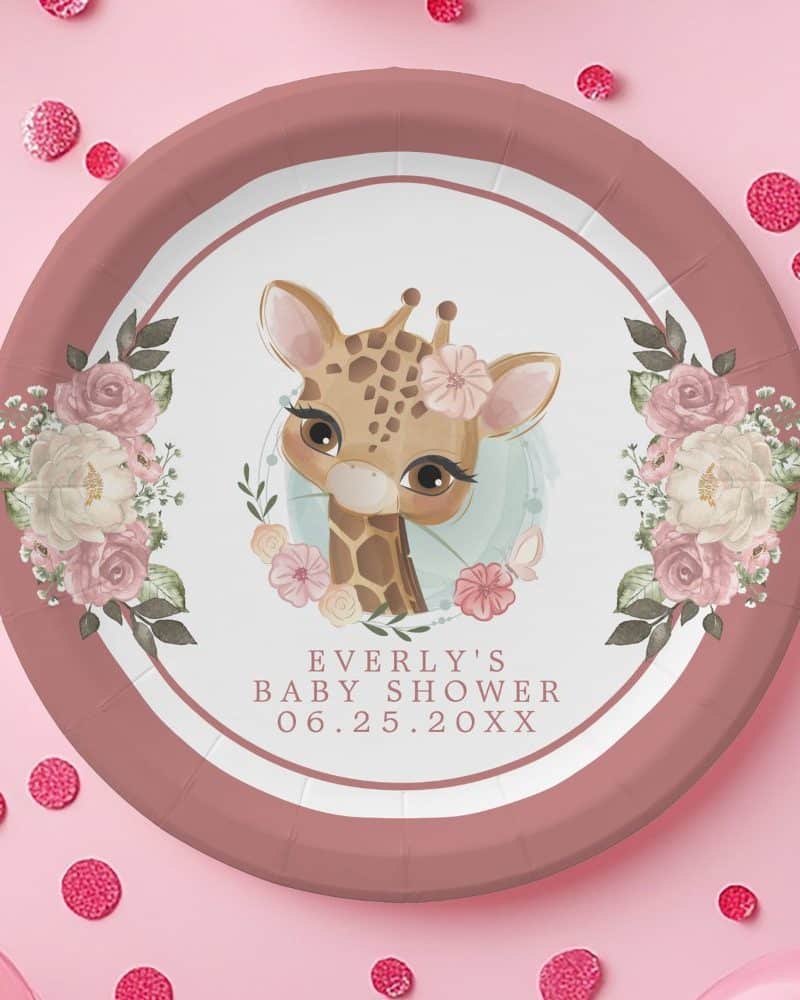 Pink baby shower paper plate featuring a cute giraffe surrounded by flowers. The plate is personalized with the baby's name and shower date.