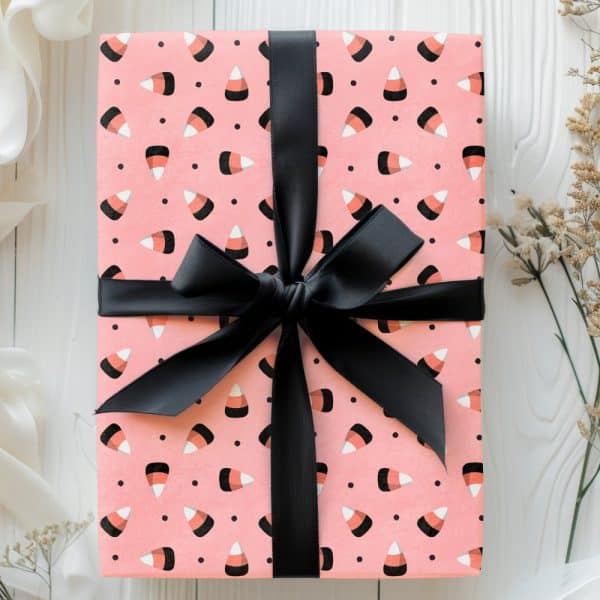 Pink Gift Box With Candy Corn Pattern And Black Ribbon.