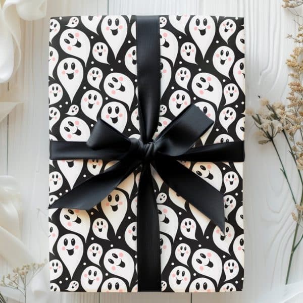 Gift Wrapped In Black And White Ghost Patterned Paper With A Black Ribbon.