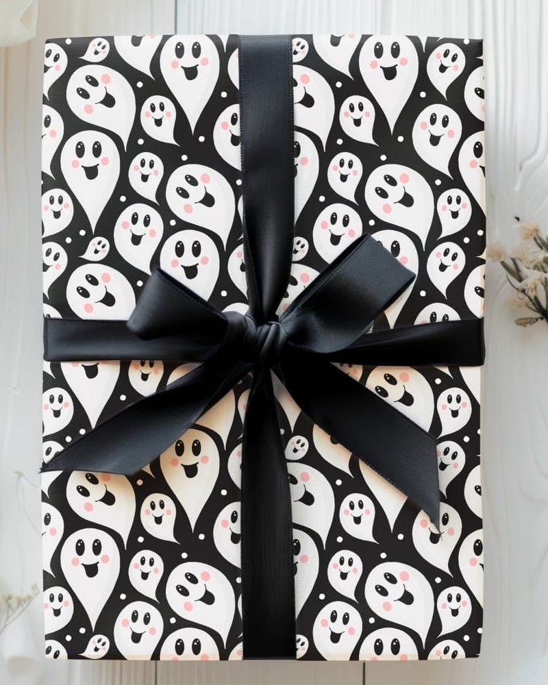 Gift wrapped in black and white ghost patterned paper with a black ribbon.