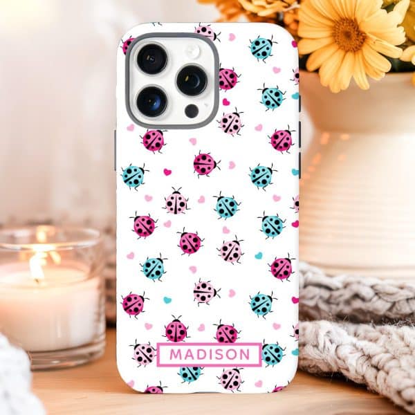 Iphone Case With A Pattern Of Pink And Blue Ladybugs And Hearts, Personalized With The Name Madison.