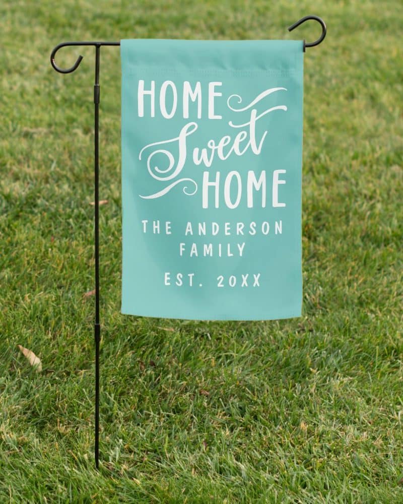 Teal Home Sweet Home yard sign with the Anderson family name and establishment year.