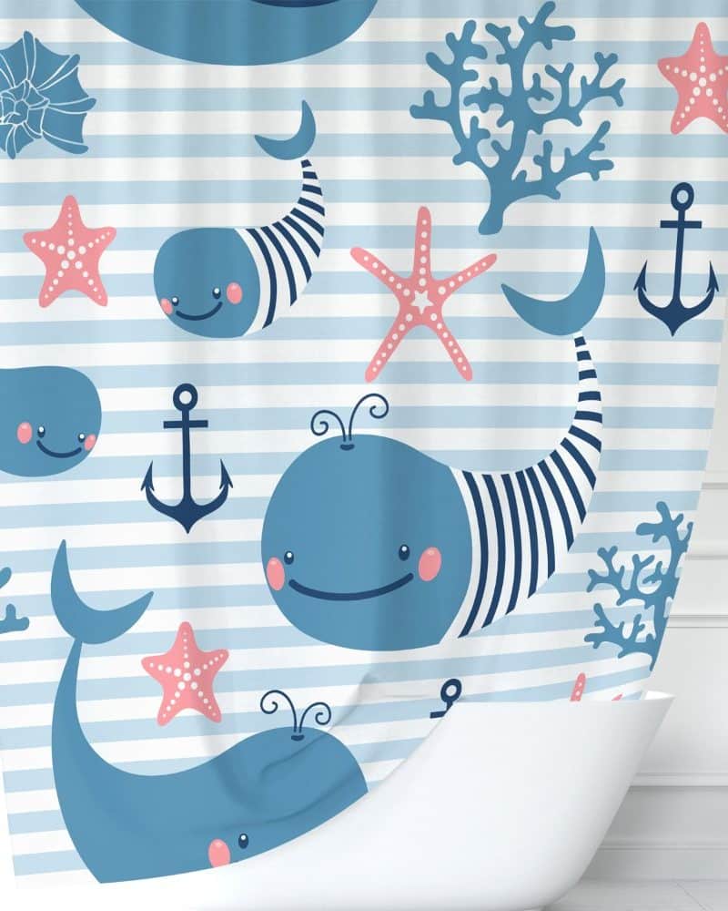 Shower curtain with a pattern of cartoon whales, starfish, anchors, and coral on blue and white stripes.