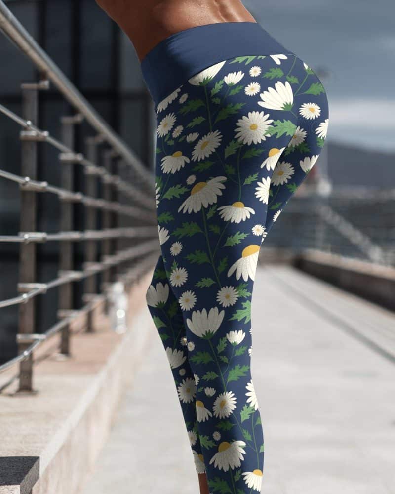 Womans legs in navy blue leggings featuring a white daisy floral print.