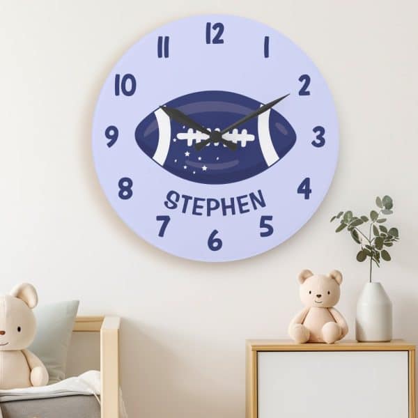 Lavender Round Clock Featuring A Navy Blue Football And The Name Stephen.