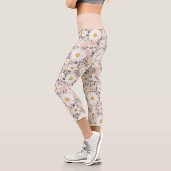 Woman Wearing Peach-Colored Cropped Leggings With A White Daisy Print.