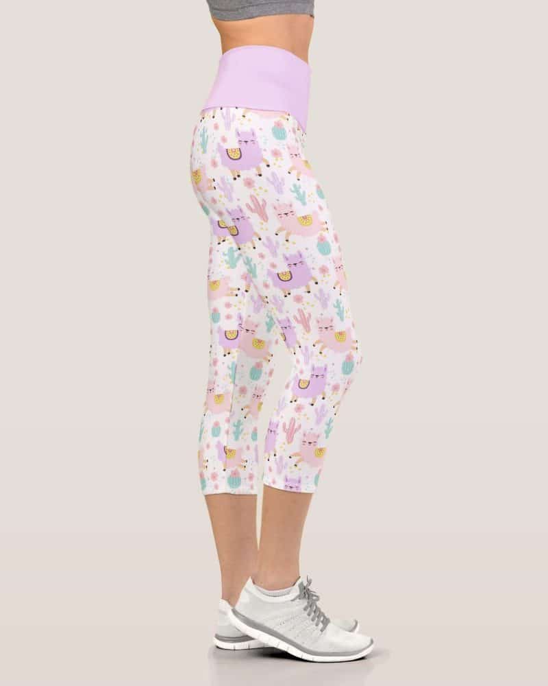 Woman wearing cropped leggings featuring a pastel llama and cactus pattern.