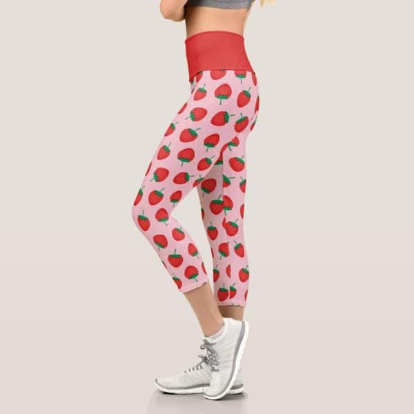 Pink And Red Cropped Leggings Featuring A Repeating Strawberry Pattern.