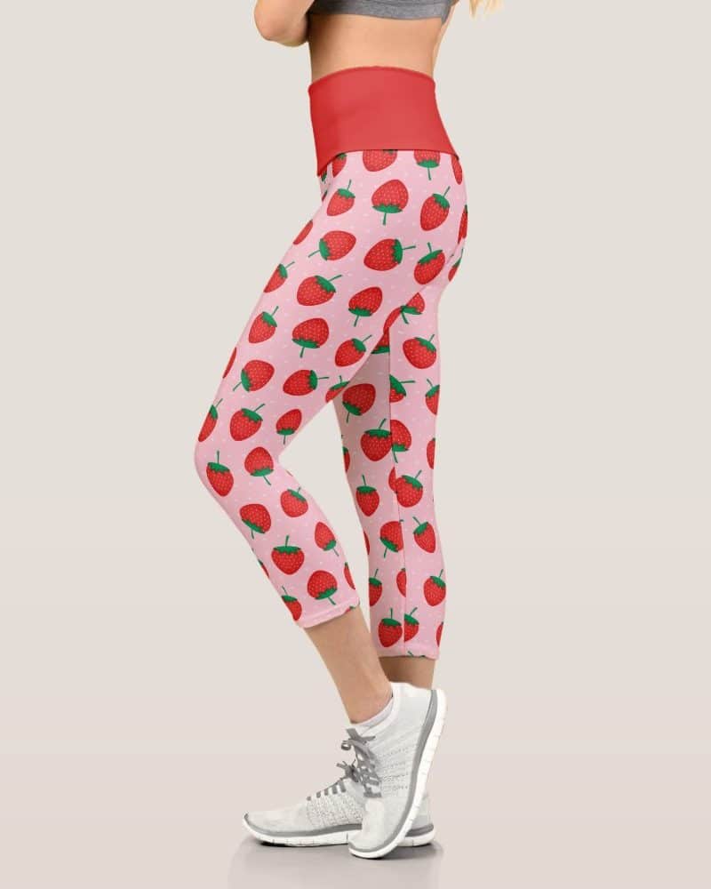 Pink and red cropped leggings featuring a repeating strawberry pattern.