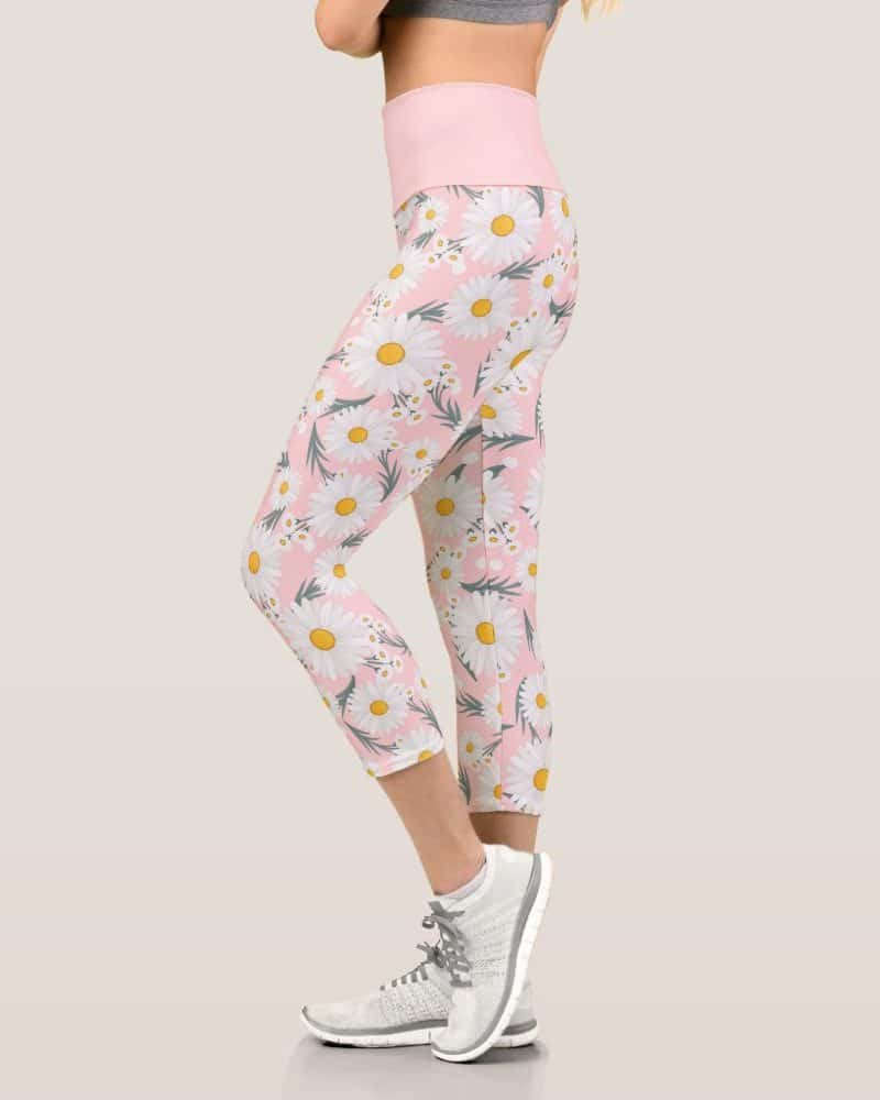 Pink capri leggings with a white daisy print.