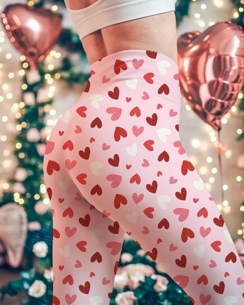 Pink leggings with a pattern of red and white hearts.
