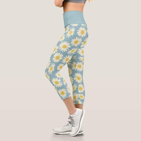 Woman Wearing Light Blue Capri Leggings With A Daisy Print.