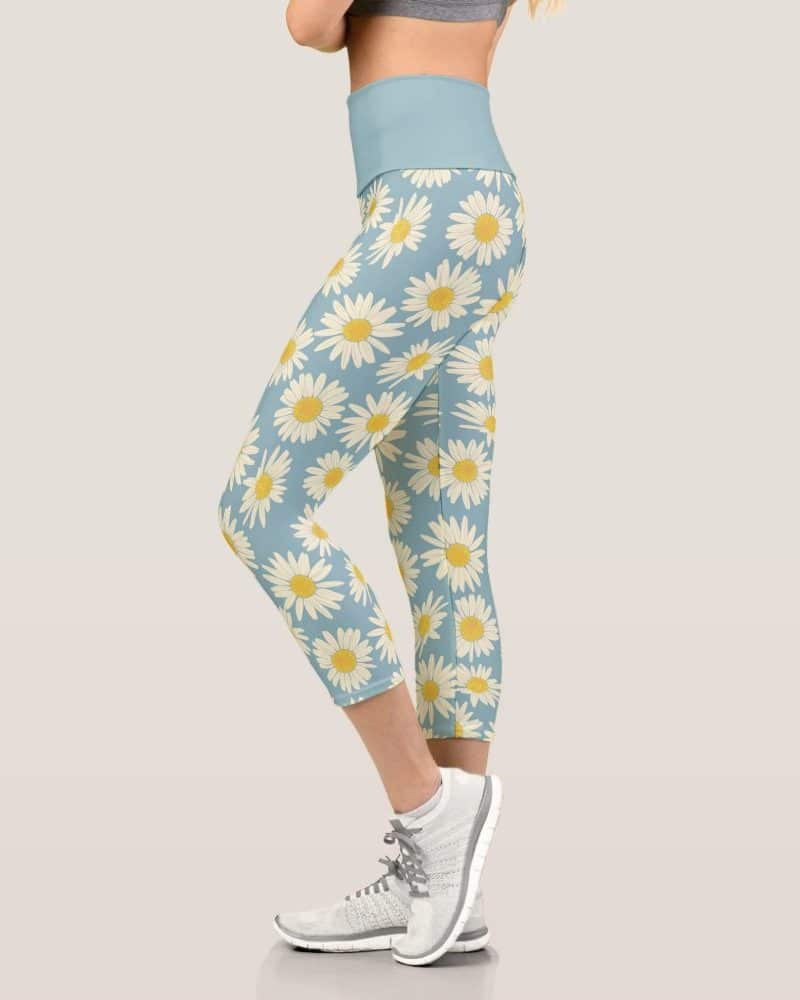 Woman wearing light blue capri leggings with a daisy print.