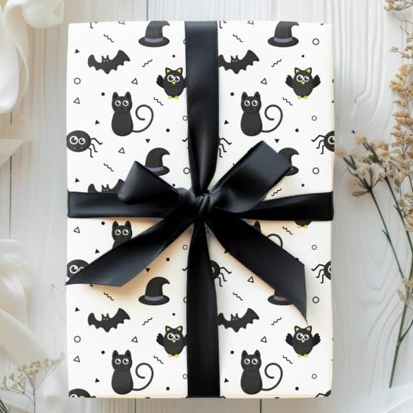 Halloween Gift Wrapped In Black And White Paper Featuring Black Cats, Bats, Owls, And Spiders.