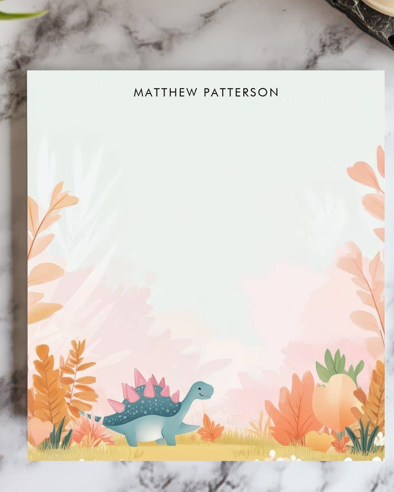 Personalized notepad featuring a teal dinosaur in a pastel landscape.