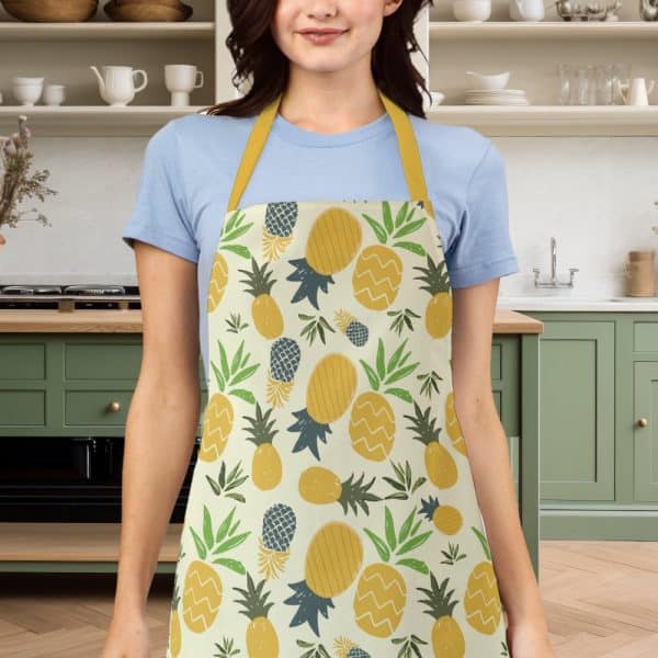 Woman Wearing A Yellow And Green Pineapple Patterned Apron.