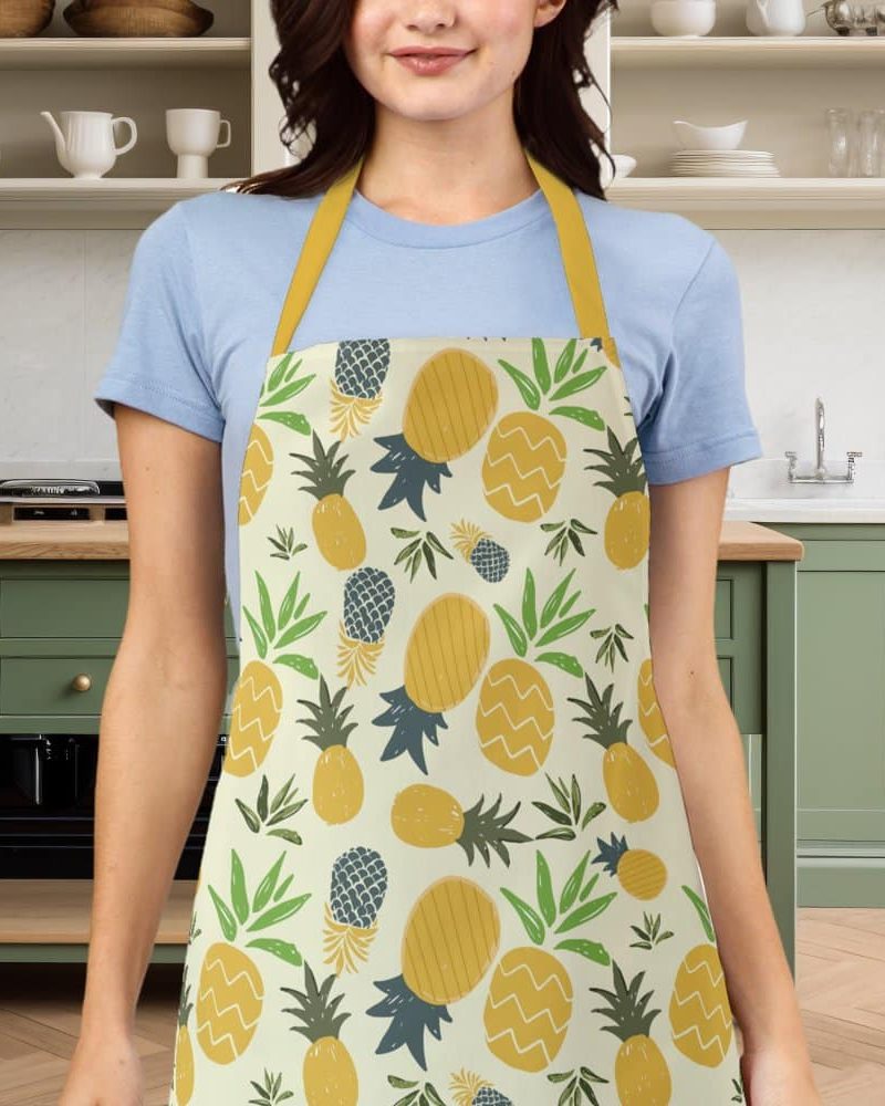 Woman wearing a yellow and green pineapple patterned apron.