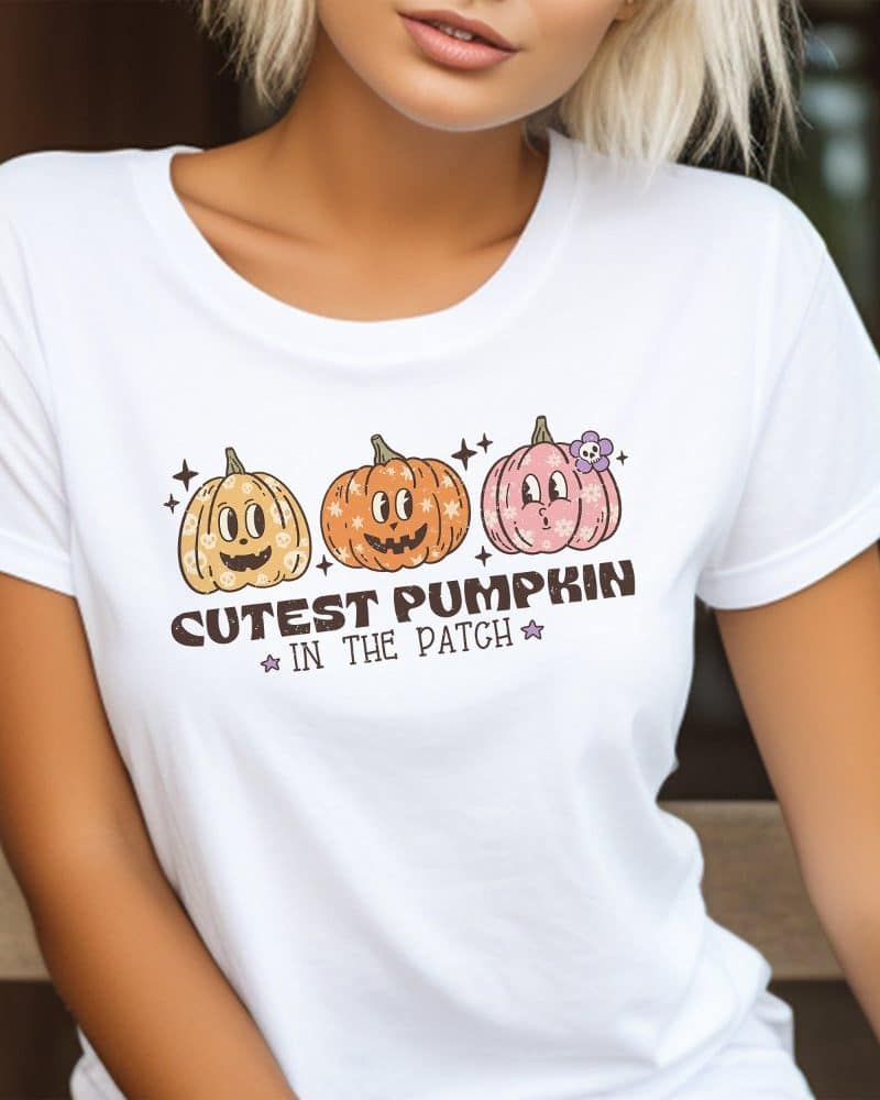 White t-shirt featuring three cute cartoon pumpkins and the text Cutest Pumpkin in the Patch.