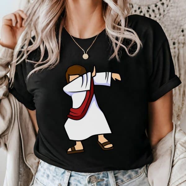 Woman Wearing A Black T-Shirt Featuring A Cartoon Depiction Of Jesus Doing The Dab.