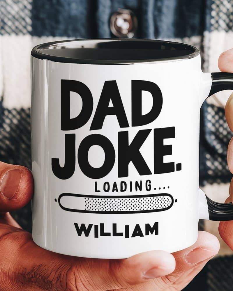 A hand holds a white coffee mug with black text that reads Dad Joke. A progress bar below says Loading, and the name William is at the bottom.