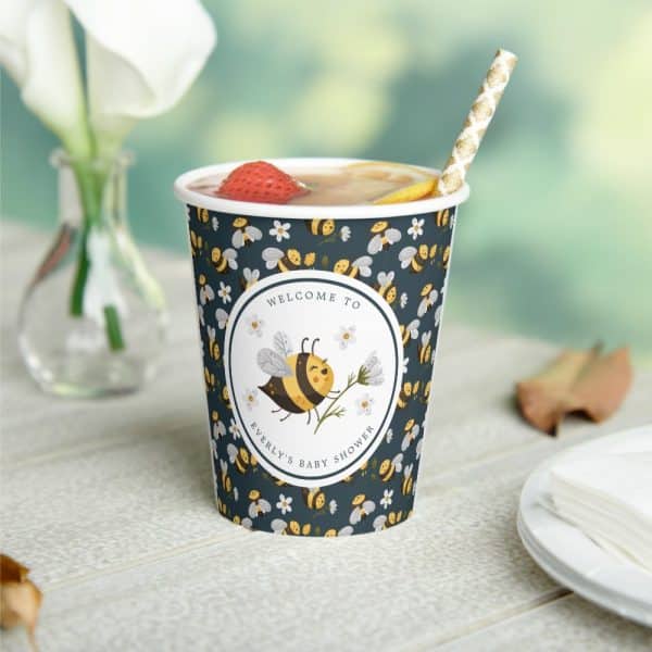 A Dark-Blue Cup With A Bee And Flower Design, Announcing Everly'S Baby Shower.