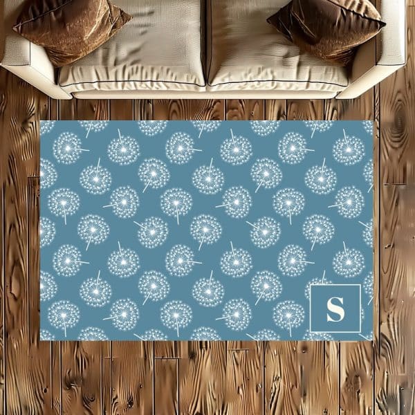 Blue Area Rug With A Repeating Dandelion Pattern And A Letter S In The Corner.