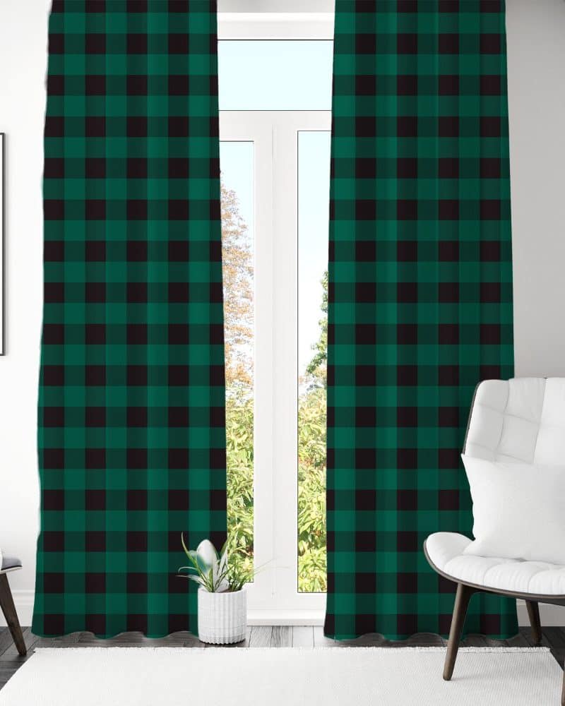 Green and black buffalo plaid curtains hanging in a window.