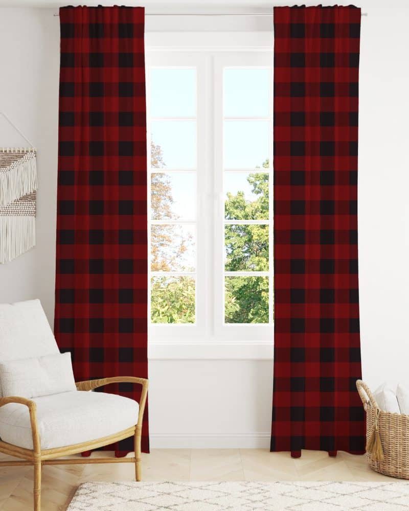Red and black buffalo plaid curtains hanging in a window.