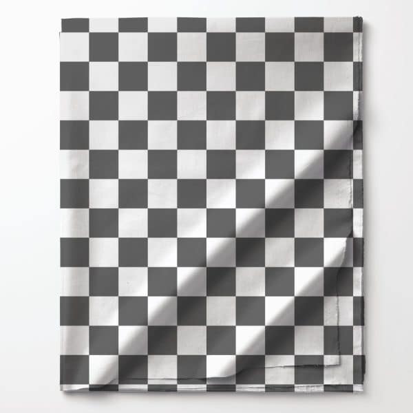 Black And White Checkered Fabric Folded On A White Background.