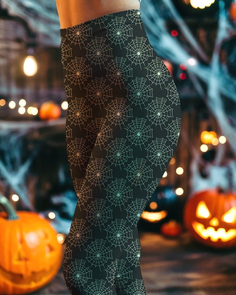 Black leggings with a pattern of light green spiderwebs.