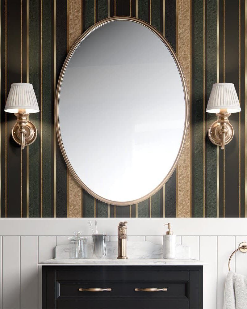 Large oval mirror flanked by wall-mounted lights above a bathroom vanity.