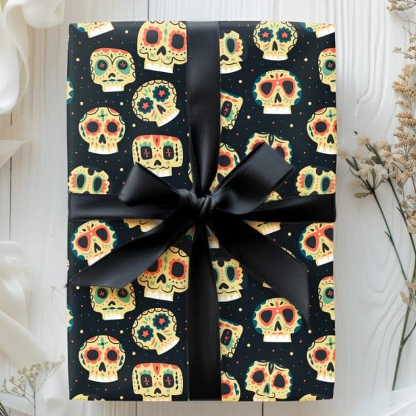 A Gift Wrapped In Black Paper Featuring A Repeating Pattern Of Colorful Sugar Skulls, Tied With A Black Ribbon.