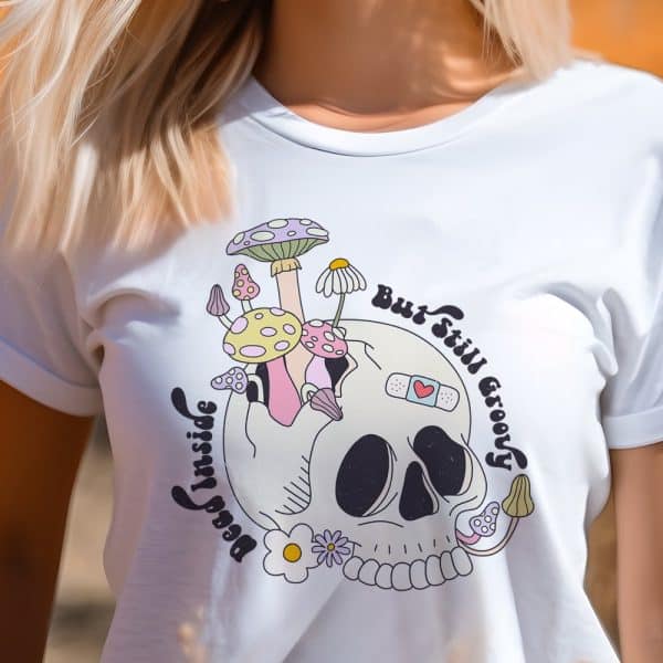 White T-Shirt Featuring A Graphic Design Of A Skull Adorned With Mushrooms And Flowers, And Text That Reads, But Still Groovy.
