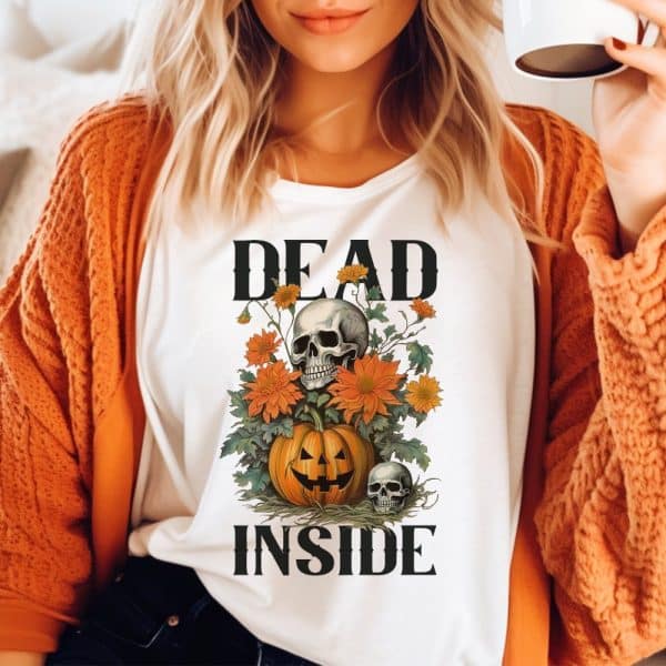 White Shirt With A Halloween Design: A Skull Nestled In Orange Flowers Atop A Jack-O'-Lantern, With The Words Dead Inside Above And Below.