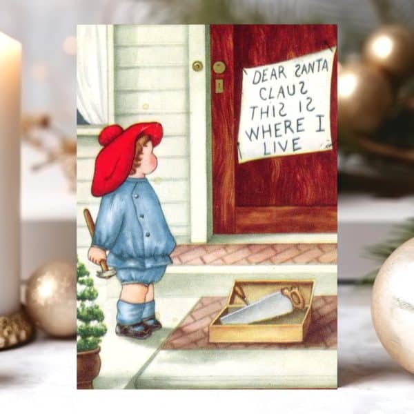 A Young Child In A Red Hat And Blue Overalls Stands On A Porch, Holding A Hammer Near A Box Of Tools And A Sign That Reads &Quot;Dear Santa Claus This Is Where I Live&Quot;.