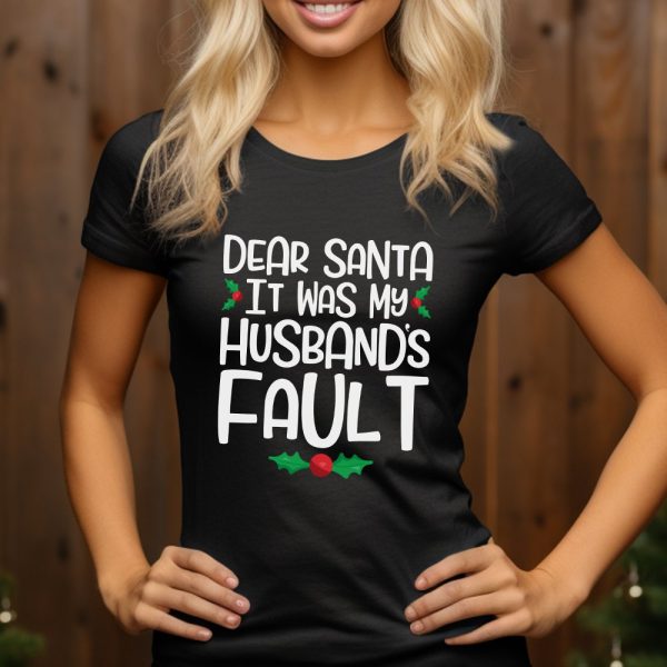Woman Wearing A Black T-Shirt With A Humorous Christmas Design That Reads, Dear Santa It Was My Husband'S Fault.
