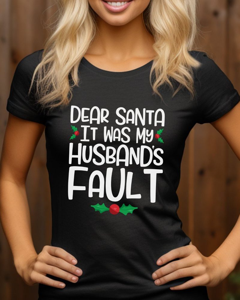Woman wearing a black t-shirt with a humorous Christmas design that reads, Dear Santa It Was My Husband's Fault.