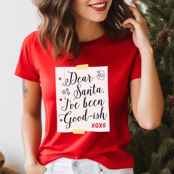 Woman Wearing A Red T-Shirt With A Christmas Design That Says Dear Santa, I'Ve Been Good-Ish.