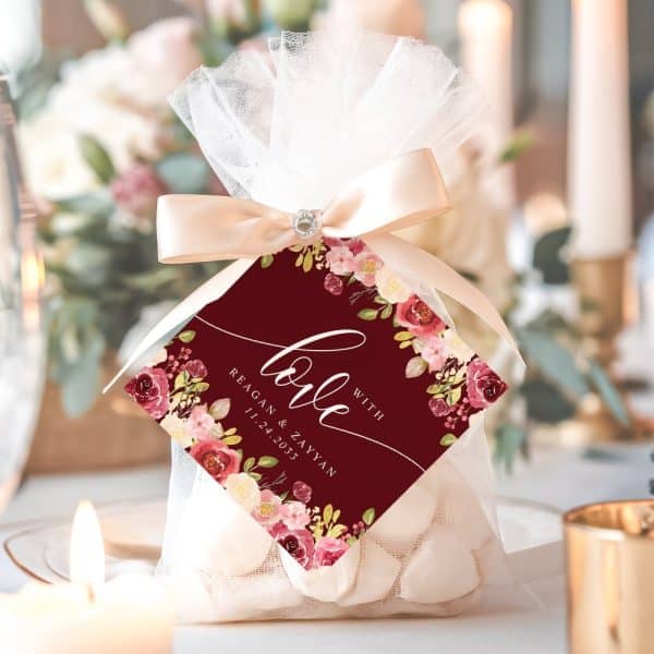 Wedding Favor Bag With A Burgundy Floral Tag That Says Love With The Couple'S Names And Wedding Date.