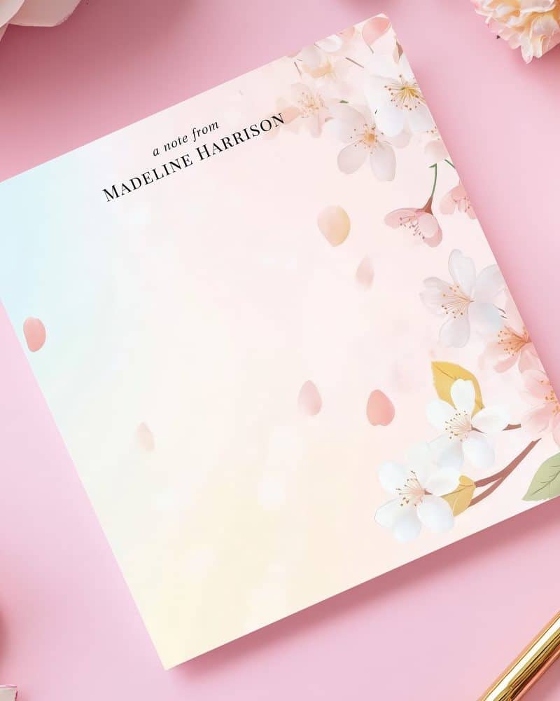 Personalized notepad featuring a pastel floral design with cherry blossoms and falling petals.