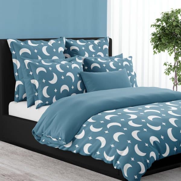 Teal Blue Duvet Cover And Pillow Shams With A White Crescent Moon And Star Pattern.