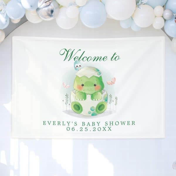 Baby Shower Banner Featuring A Cute Cartoon Dinosaur Hatching From An Egg.