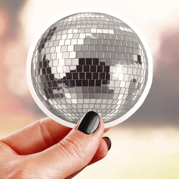 Hand Holding A Sticker Of A Disco Ball.